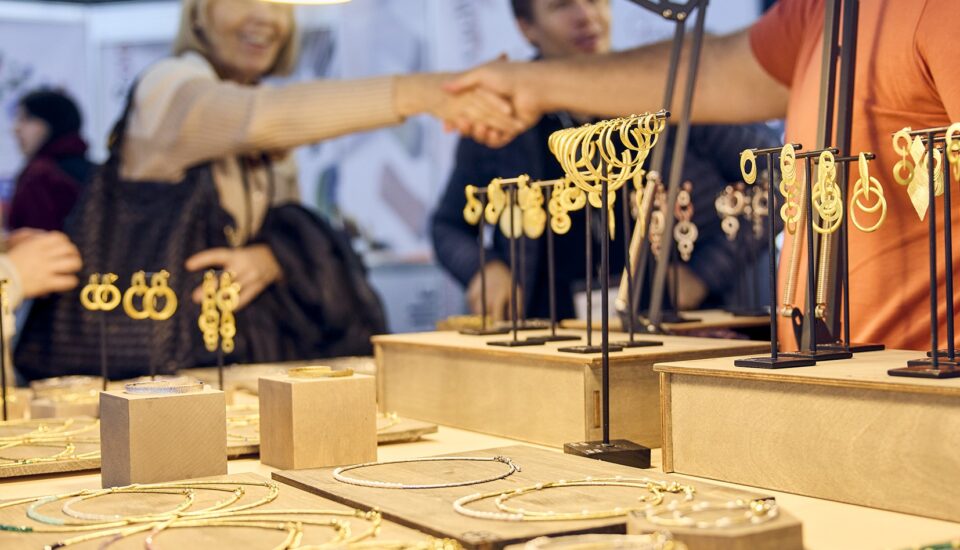 Handel mit Schmuck an einem Messestand auf der Gemworld Munich.
