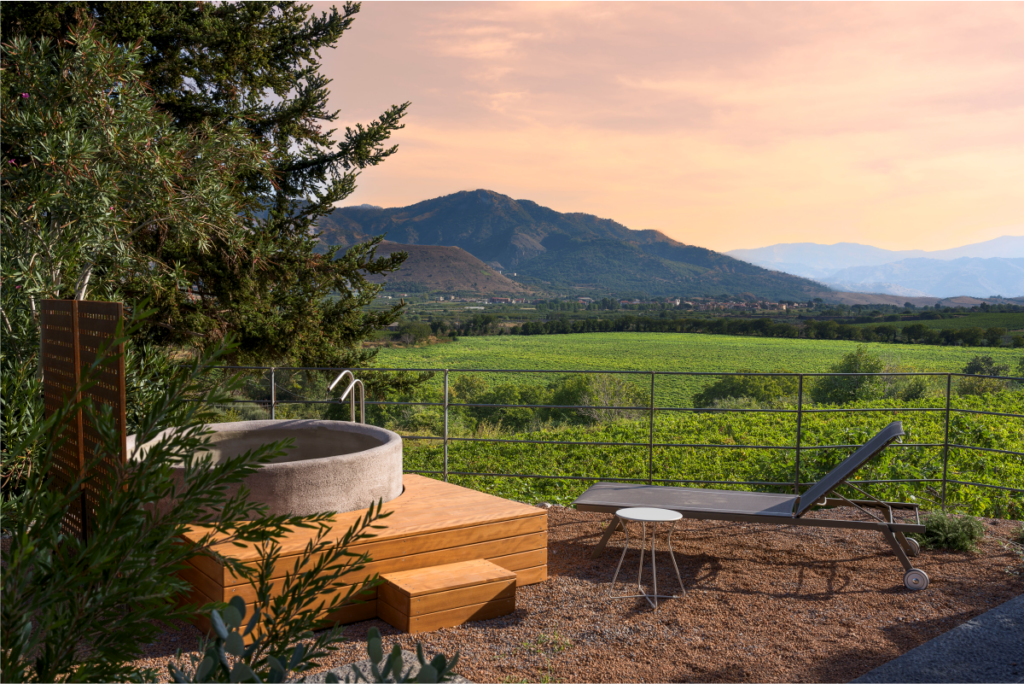 An outdoor bathtub with a view of the landscape
