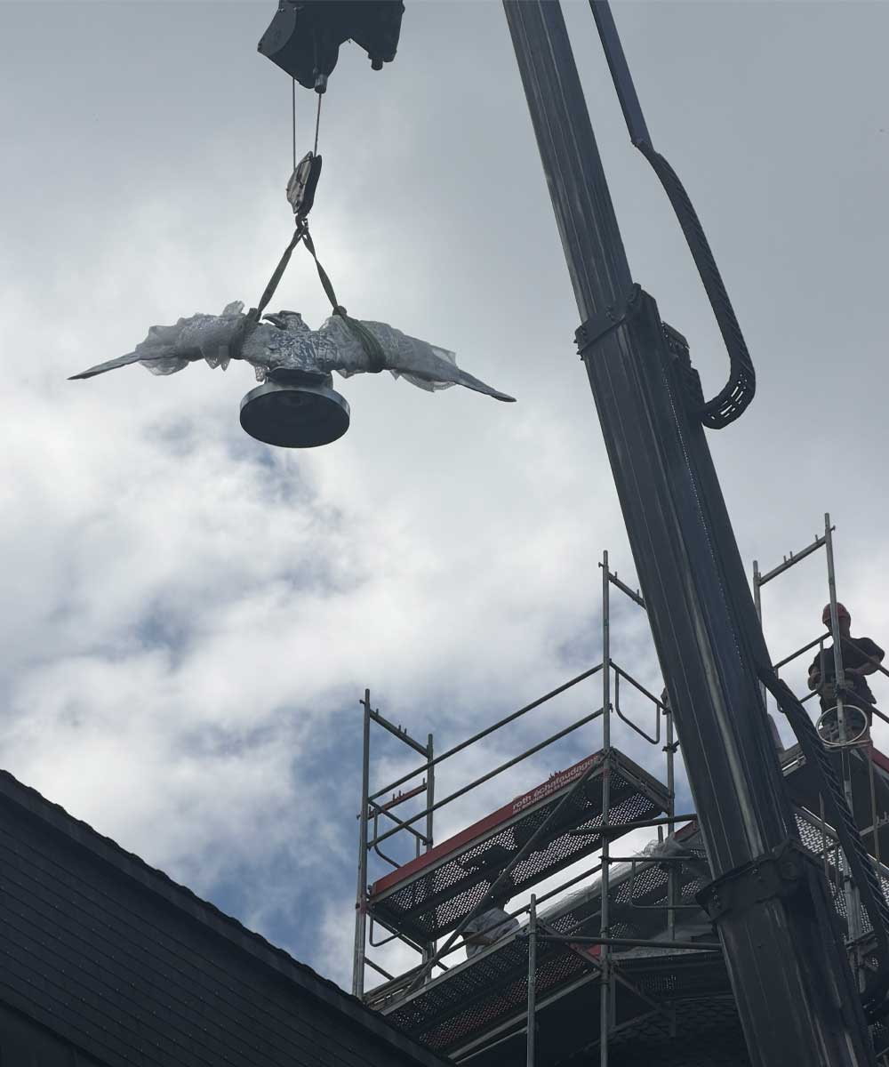 The eagle statue at the Eberhard & Co. headquarters in La Chaux-de-Fonds is suspended from a crane