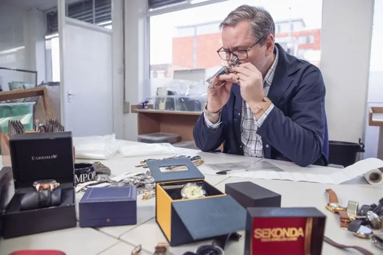 A man is examining a watch